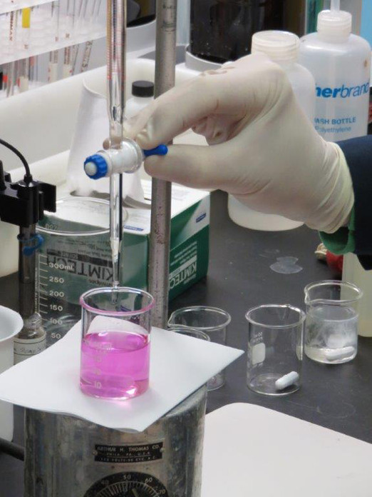 A sample is analyzed by titration method in the Analytical Laboratory.