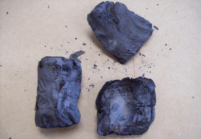 Mutilated currency that is badly burned by fire.