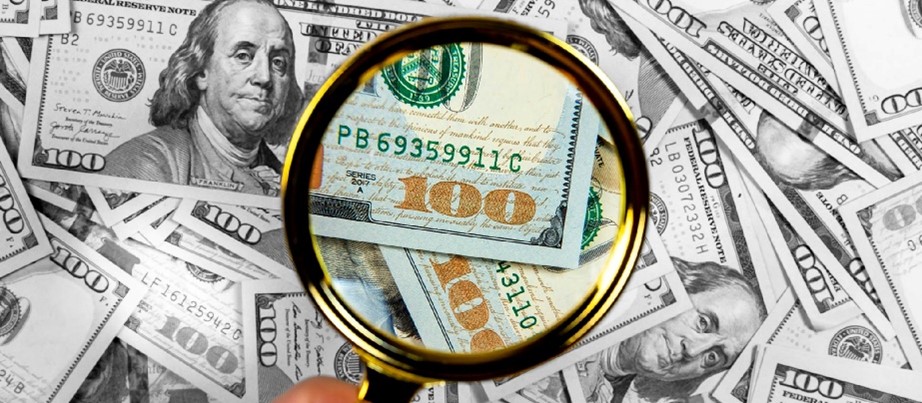 Magnifying glass over $100s